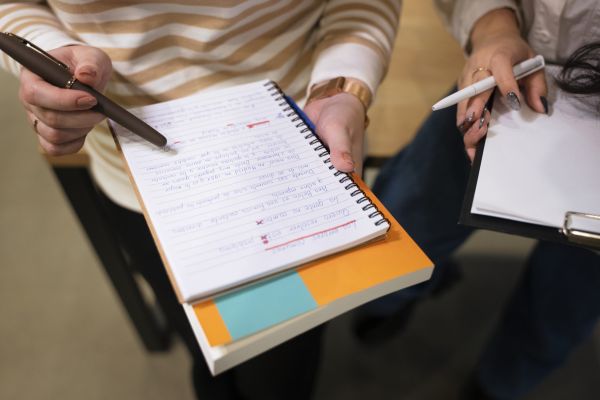 high-angle-people-correcting-grammar-mistakes